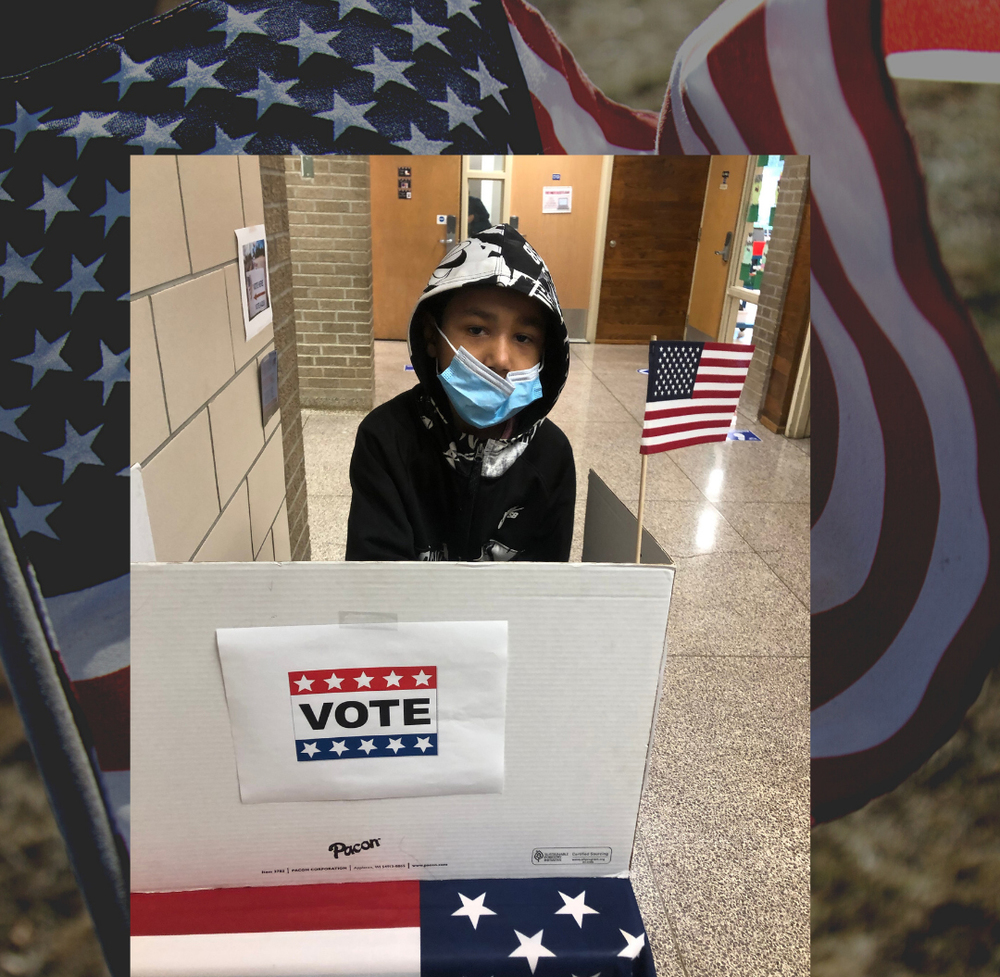 Boy casting his ballot at voting station.